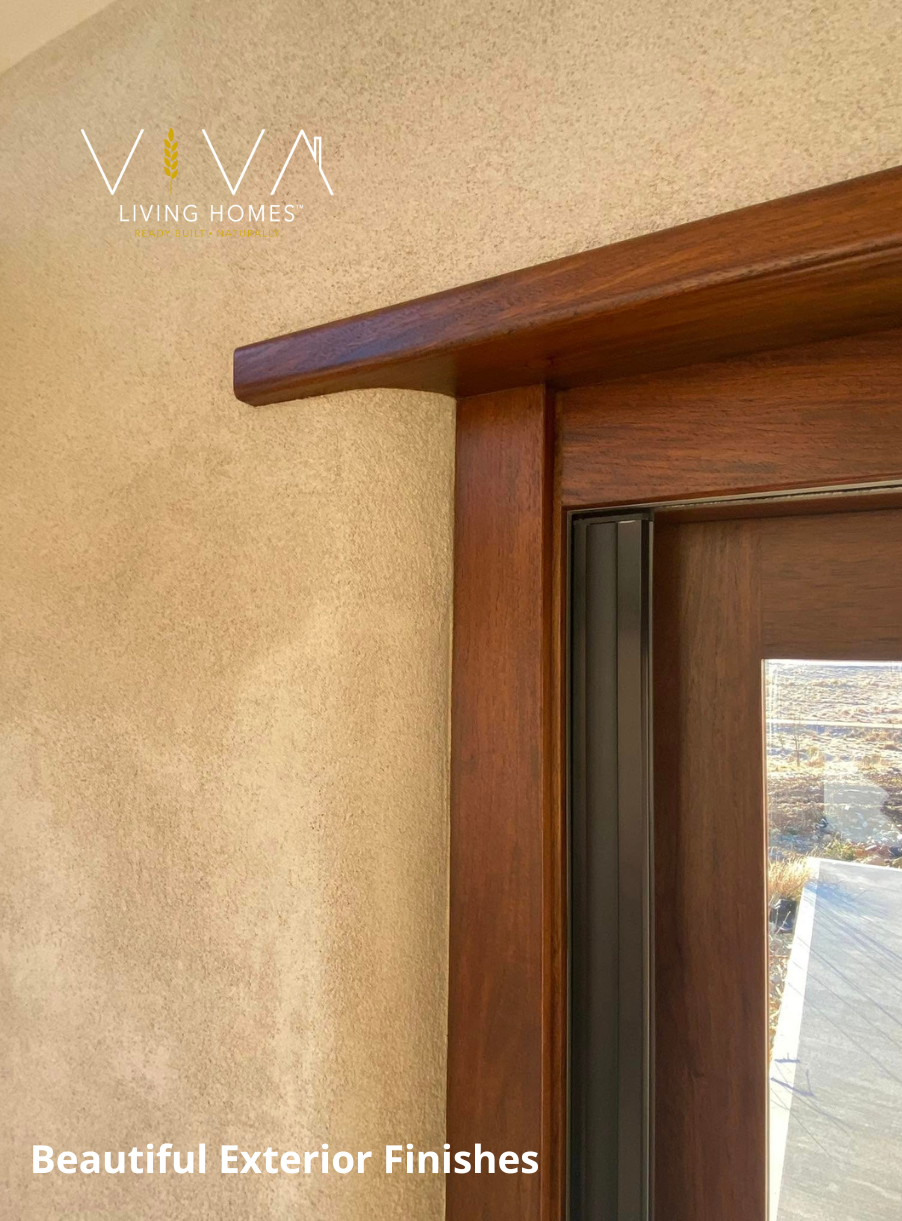 Close-up of a Viva home exterior with rendered straw wall and timber-framed door detail