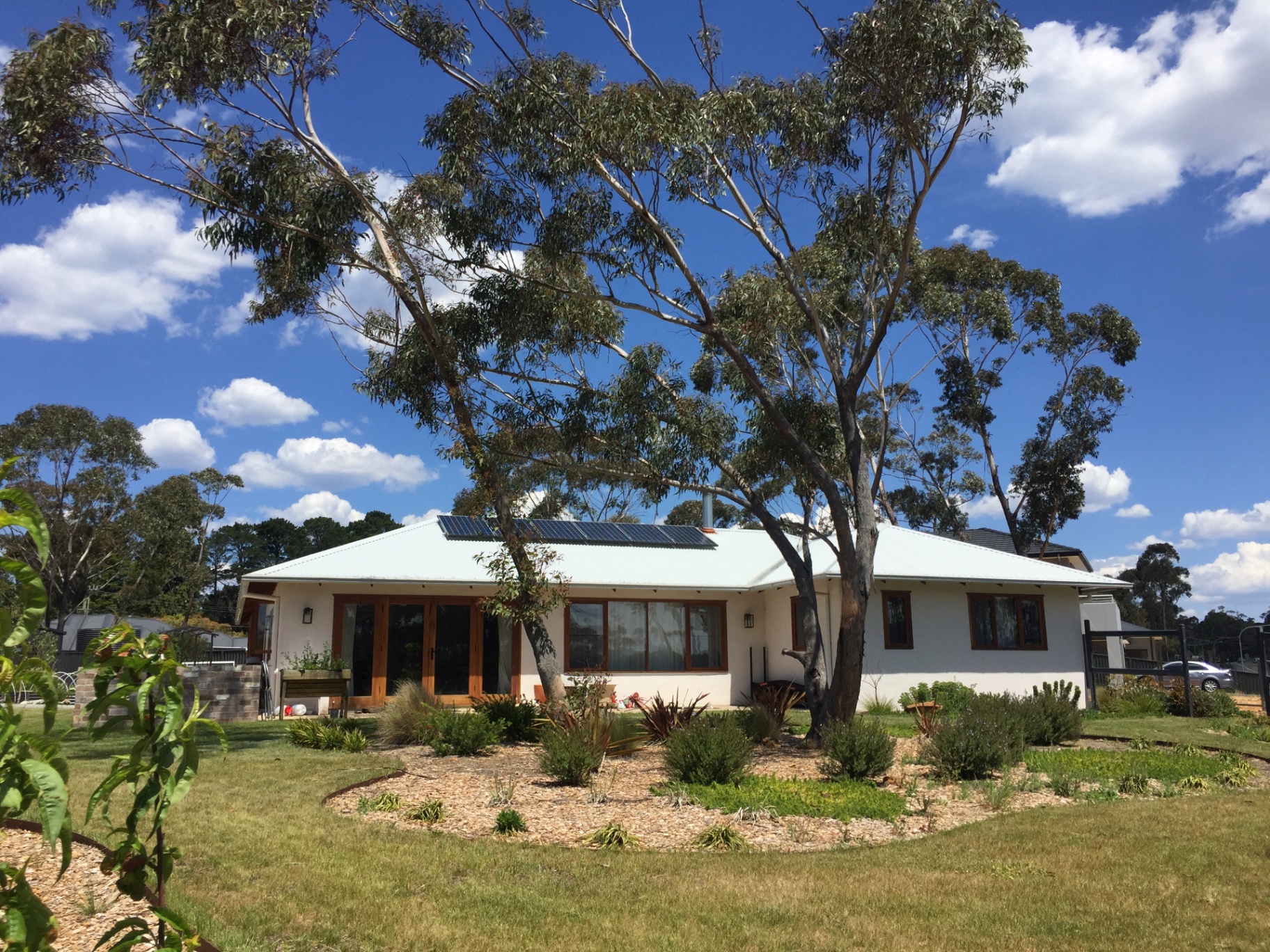 Viva Panel home with hipped metal roof, timber-framed windows and established garden