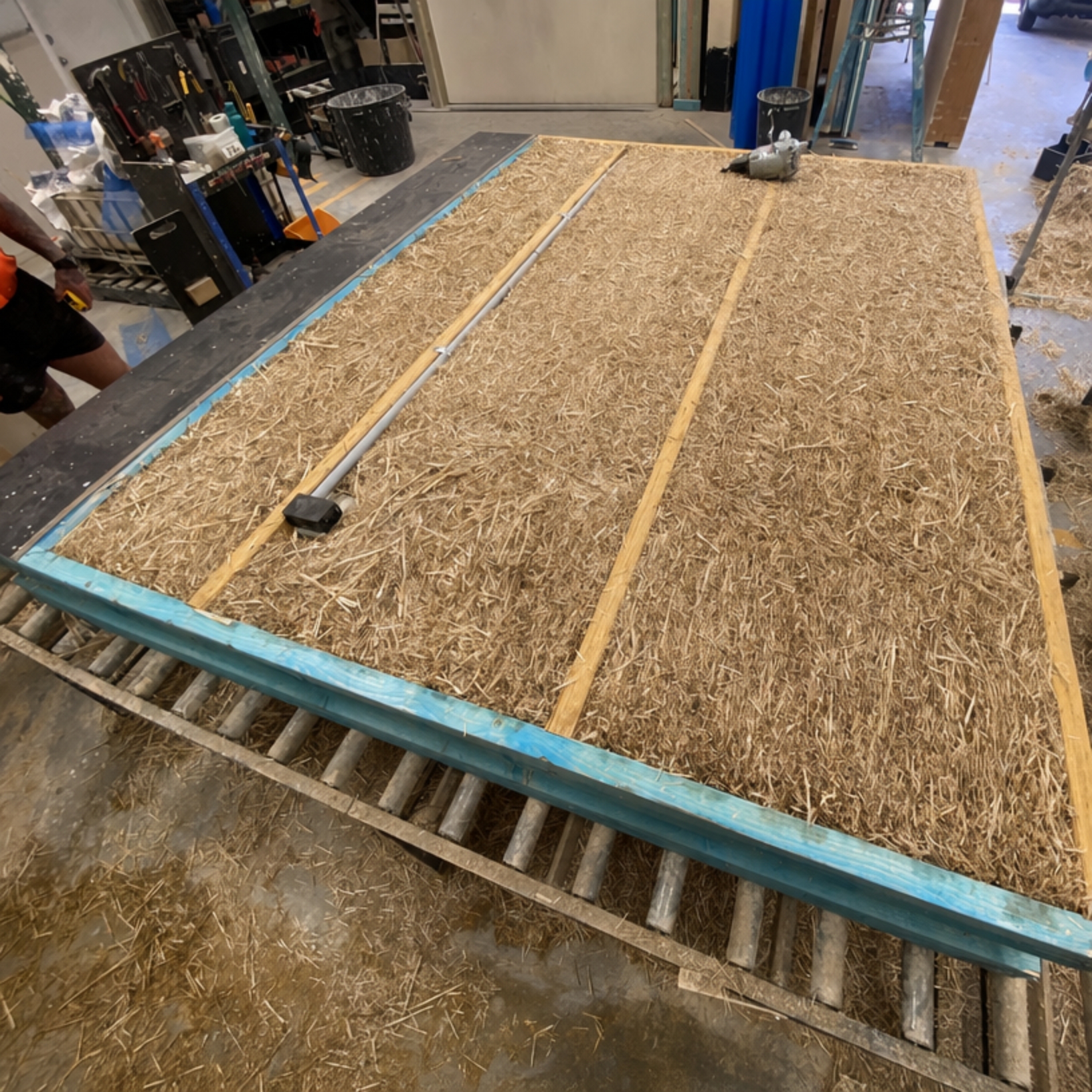 Straw and timber Viva Panel on the factory workbench, ready for rendering